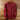 Red long-sleeve shirt on a wooden hanger against a wooden background