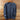 Blue long-sleeve shirt on a wooden hanger against a wooden background