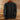 Dark gray long-sleeve shirt with brown buttons on a wooden hanger against a wooden background